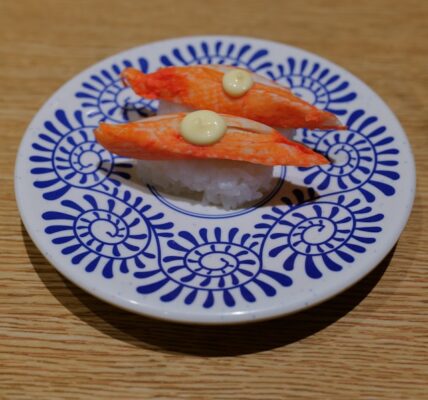 Colorful assorted sushi plates on a conveyor belt in Tokyo