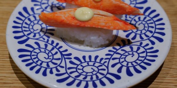 Colorful assorted sushi plates on a conveyor belt in Tokyo